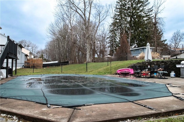 view of swimming pool featuring a patio area and a yard