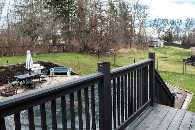 wooden terrace featuring a yard