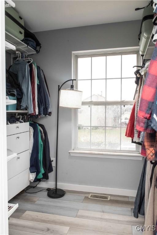 walk in closet featuring light hardwood / wood-style flooring