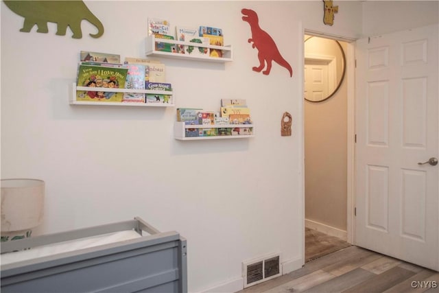 laundry room with hardwood / wood-style floors