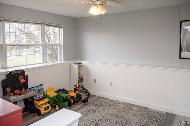 rec room featuring hardwood / wood-style floors and ceiling fan