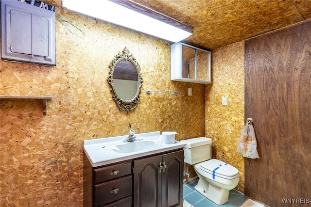 bathroom featuring tile patterned flooring, vanity, and toilet