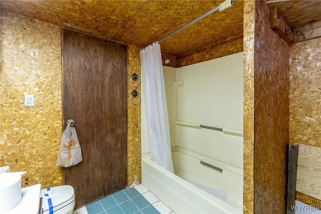 bathroom with tile patterned floors, shower / tub combo, and toilet