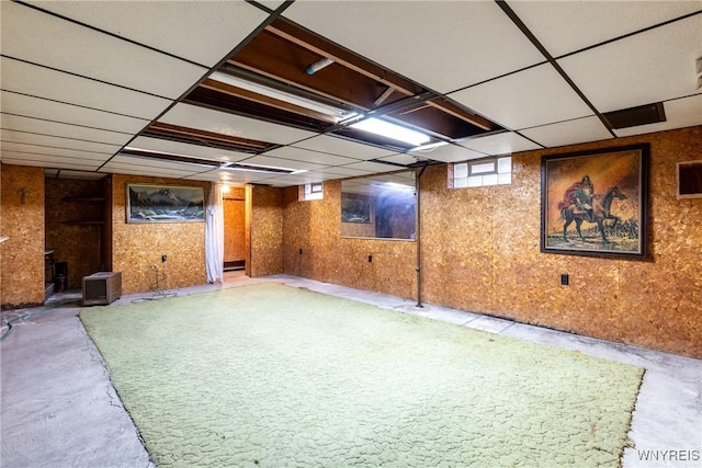 basement with a paneled ceiling