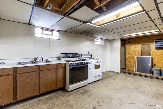 kitchen featuring white gas range and sink