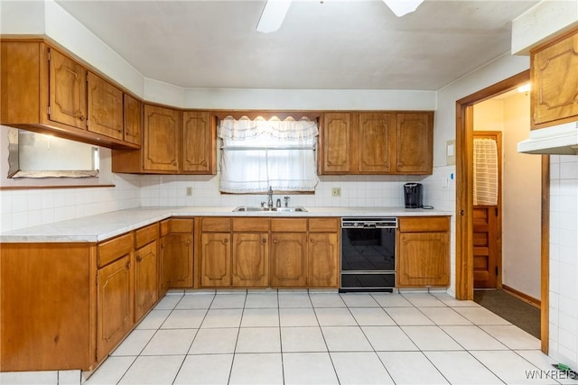 kitchen featuring dishwasher, decorative backsplash, sink, and light tile patterned floors