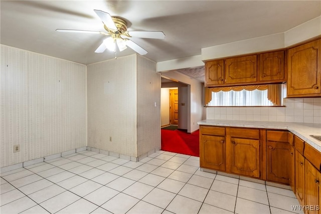 kitchen featuring tasteful backsplash, ceiling fan, and light tile patterned flooring