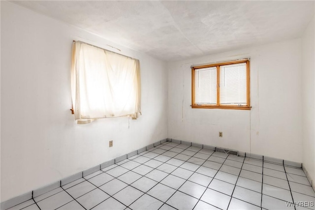 unfurnished room featuring light tile patterned floors