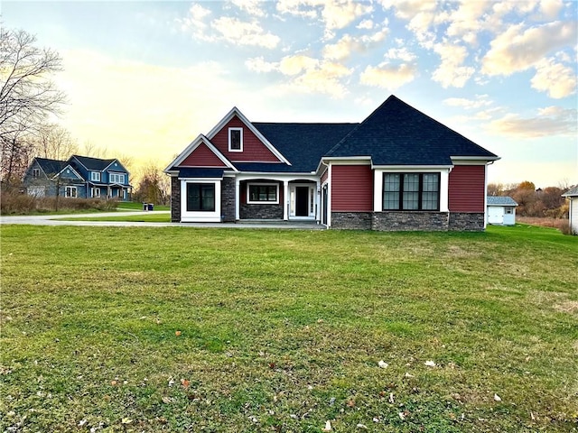 craftsman-style home featuring covered porch and a yard