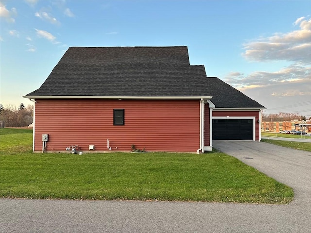 view of side of home with a lawn