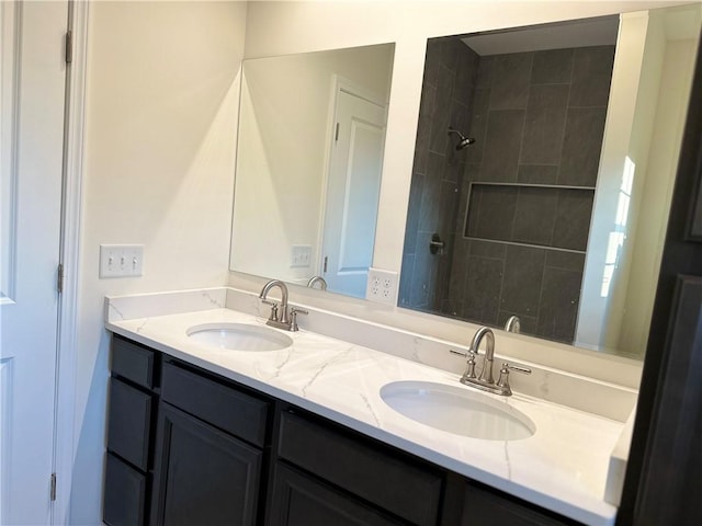 bathroom featuring vanity and tiled shower