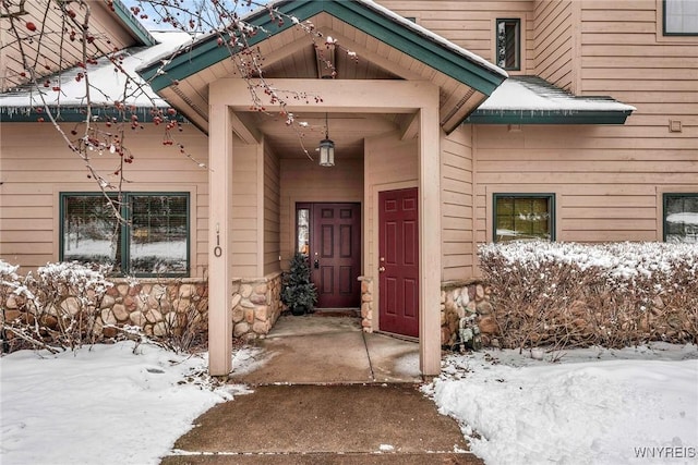 view of snow covered property entrance