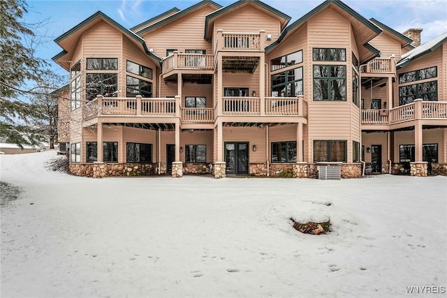 view of snow covered rear of property