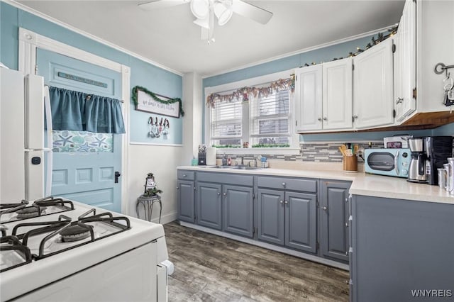 kitchen with gray cabinetry, white cabinetry, sink, dark wood-type flooring, and white appliances