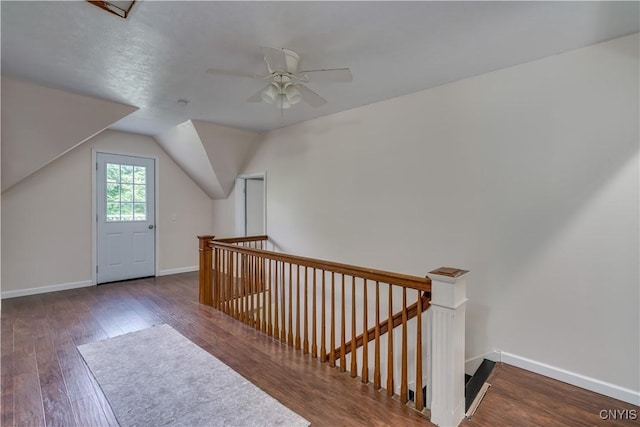 bonus room with ceiling fan, dark wood-type flooring, and vaulted ceiling