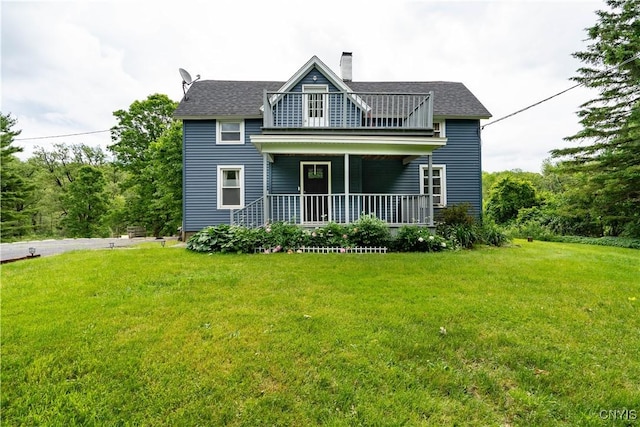 back of property featuring a lawn, a balcony, and covered porch