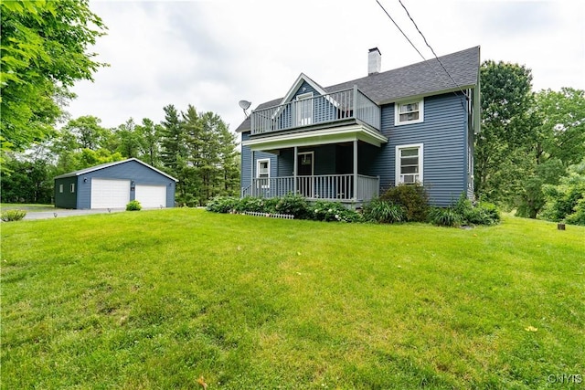 rear view of house with a balcony, an outdoor structure, covered porch, a garage, and a lawn