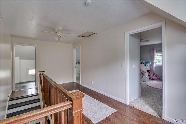 hallway with dark hardwood / wood-style flooring and lofted ceiling