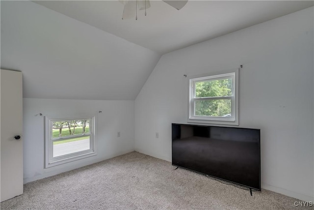 bonus room featuring plenty of natural light, light carpet, and vaulted ceiling