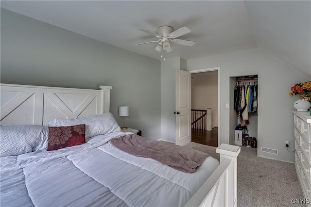 carpeted bedroom with a closet, ceiling fan, and lofted ceiling