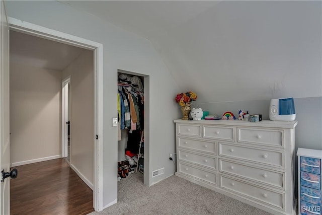 bedroom with hardwood / wood-style floors, vaulted ceiling, a closet, and beverage cooler