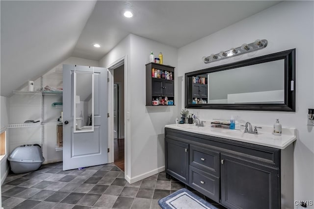 bathroom with vanity and vaulted ceiling