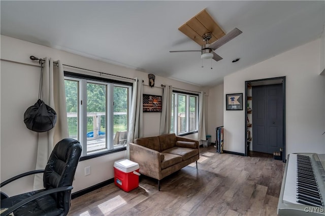 office featuring hardwood / wood-style floors, heating unit, vaulted ceiling, and ceiling fan