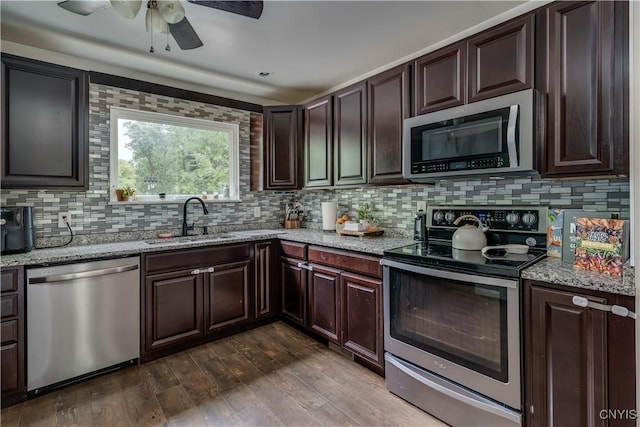 kitchen with dark hardwood / wood-style flooring, decorative backsplash, sink, and stainless steel appliances