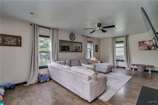 living room featuring a wealth of natural light, dark hardwood / wood-style flooring, and ceiling fan