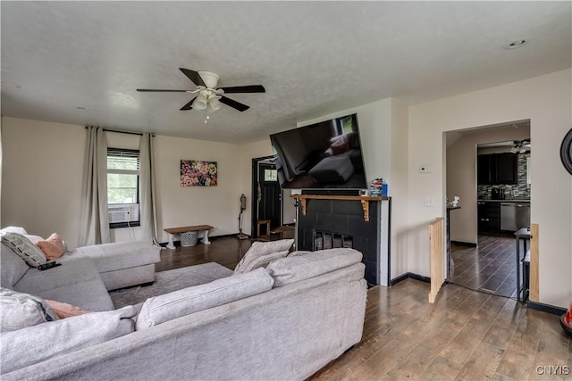 living room featuring ceiling fan, a fireplace, and hardwood / wood-style flooring