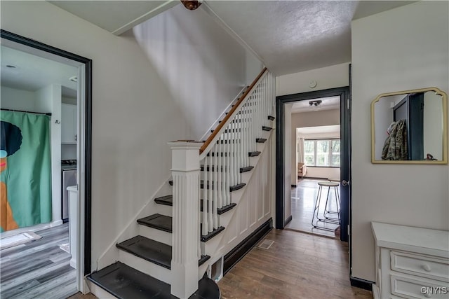 staircase featuring hardwood / wood-style flooring