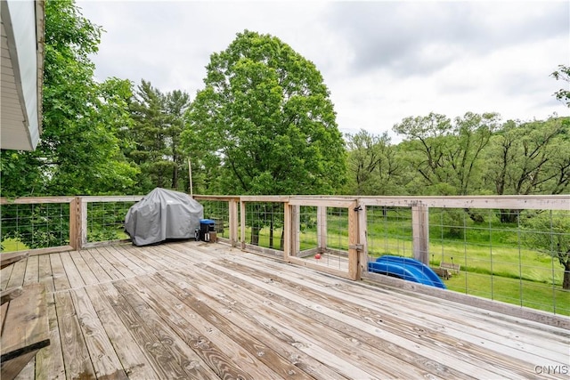 wooden terrace featuring area for grilling