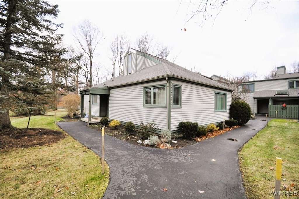 view of property exterior featuring a lawn