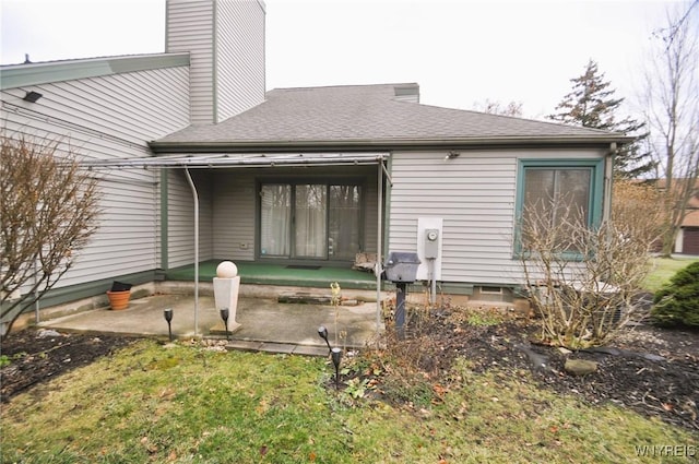 back of house with a yard and a patio