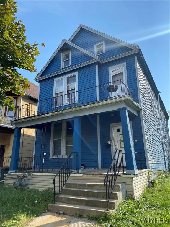 view of front of home with a porch and a balcony