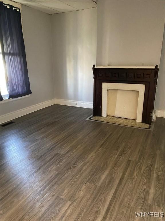 unfurnished living room featuring wood-type flooring