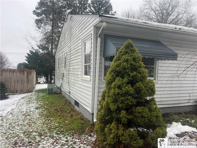 view of snowy exterior featuring central air condition unit