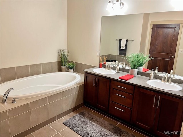 bathroom featuring vanity, tile patterned floors, and tiled tub