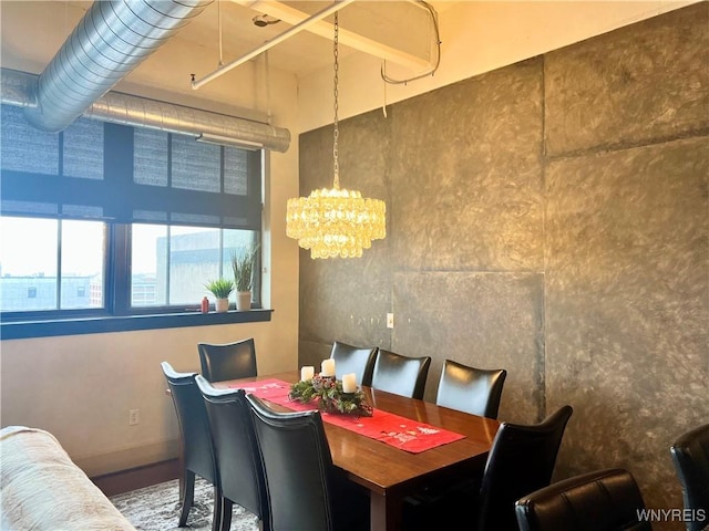 dining space with an inviting chandelier