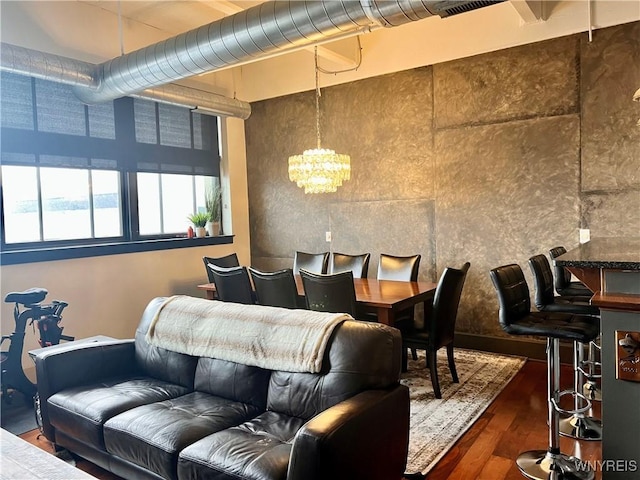 interior space featuring hardwood / wood-style floors and an inviting chandelier