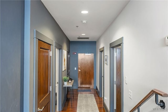 hallway with dark hardwood / wood-style flooring