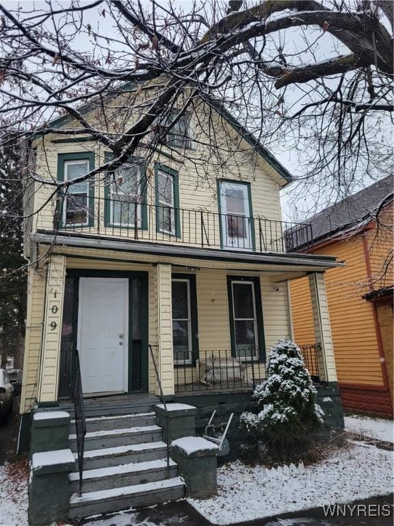 view of front of house with covered porch and a balcony