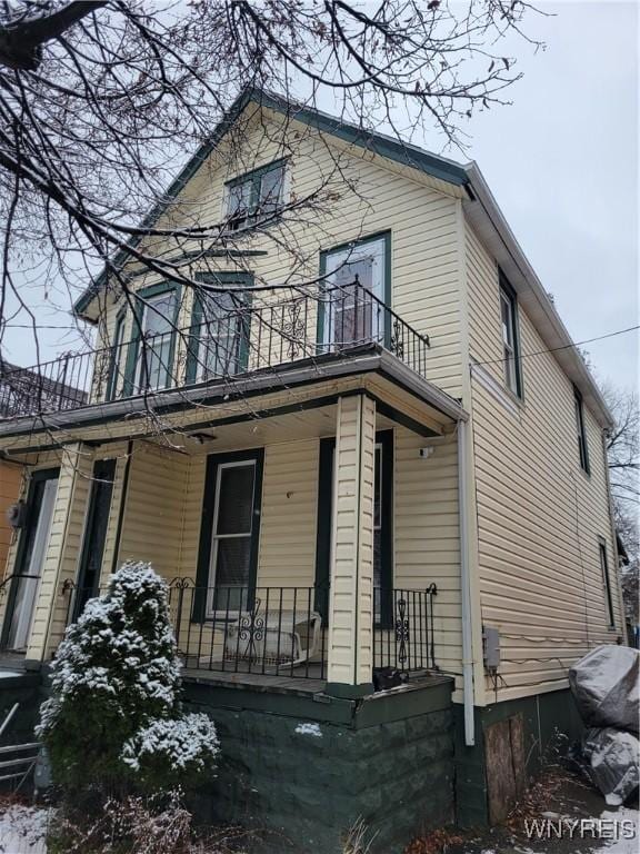 view of front of house with a porch and a balcony