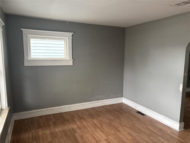 spare room with wood-type flooring