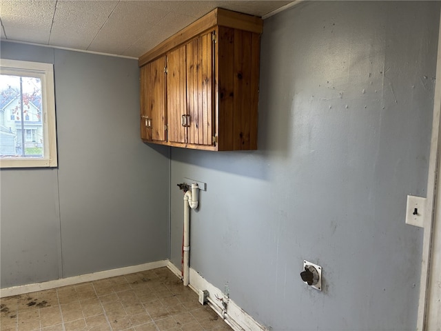 clothes washing area with hookup for an electric dryer and cabinets