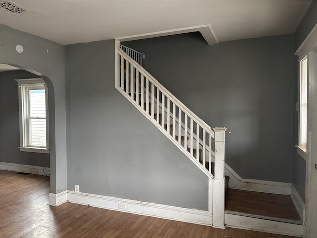 stairs featuring hardwood / wood-style floors