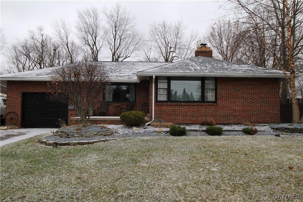 view of front of house with a garage and a front lawn