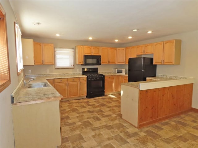 kitchen with kitchen peninsula, sink, black appliances, and light brown cabinets