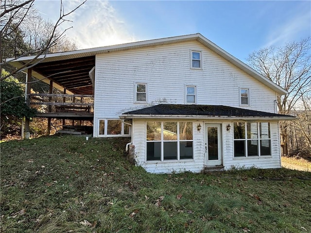 rear view of house featuring a yard and a wooden deck