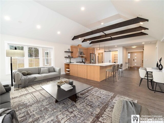 living room with lofted ceiling with beams and light hardwood / wood-style flooring